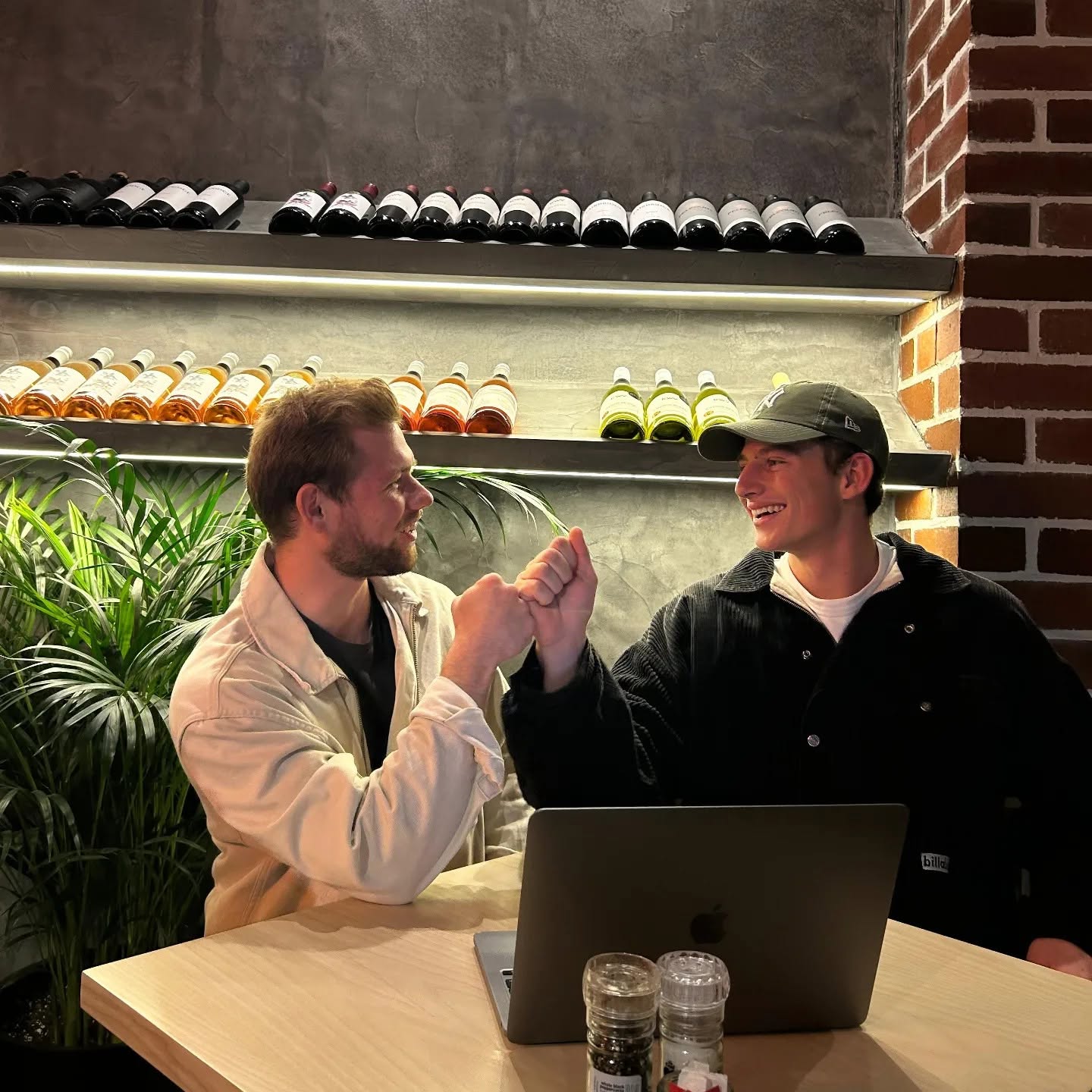 Two people collaborating over a laptop in a Jet Fuel Digital social post